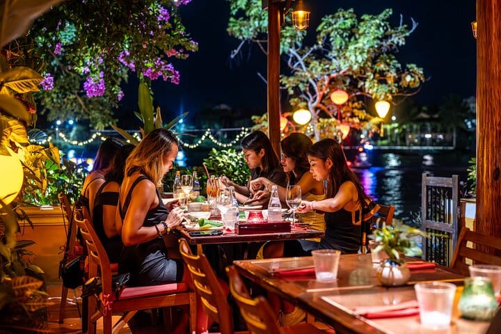 An intimate riverside setting — Private table of six enjoys the magic of SecretEATS, with Hoi An’s iconic lanterns glowing in the background.