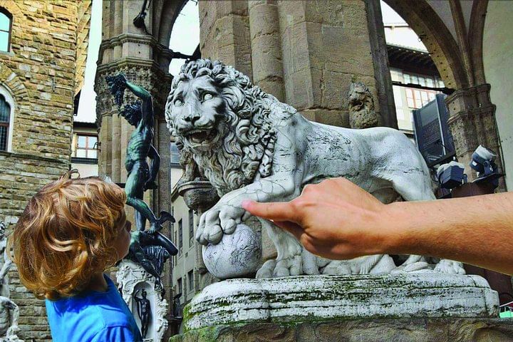 View of a bronze Lion sculpture in the Loggia dei Lanzi in Signoria Square. In the background you can see the