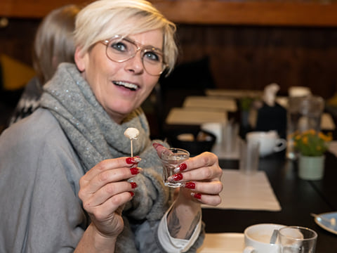 A guest showing off a bite of fermented shark