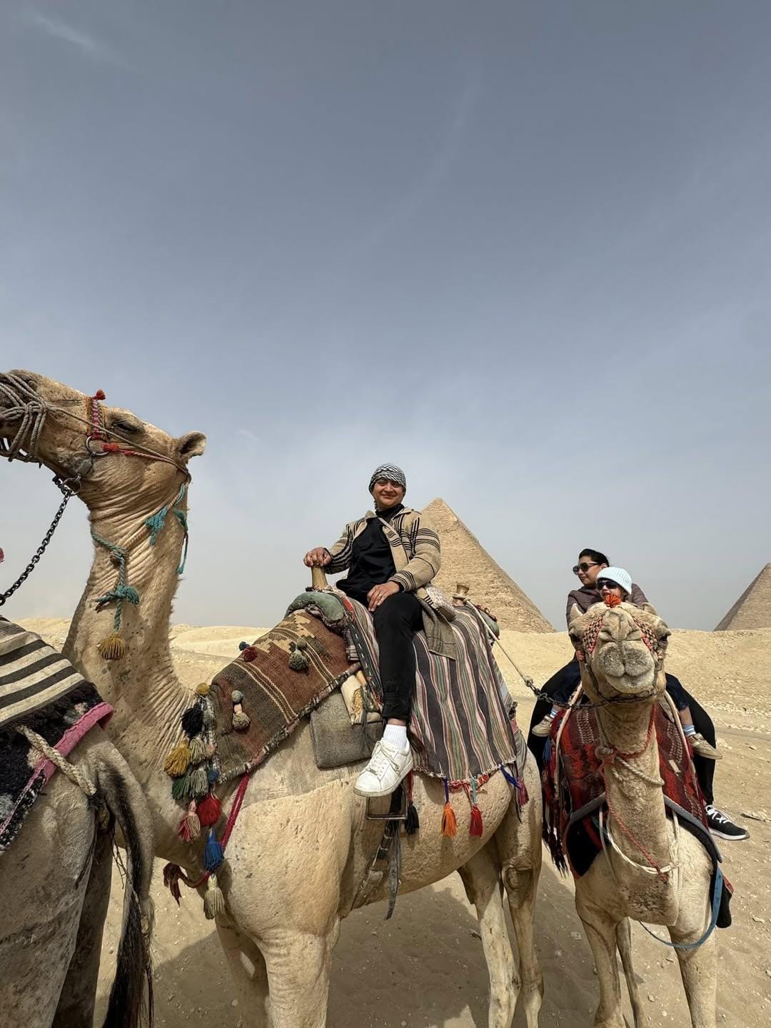 Guest riding camel at Giza plateau – Egypt adventure tour.