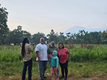 Travelers admiring the scenic view of Mount Kilimanjaro during their Marangu day tour.