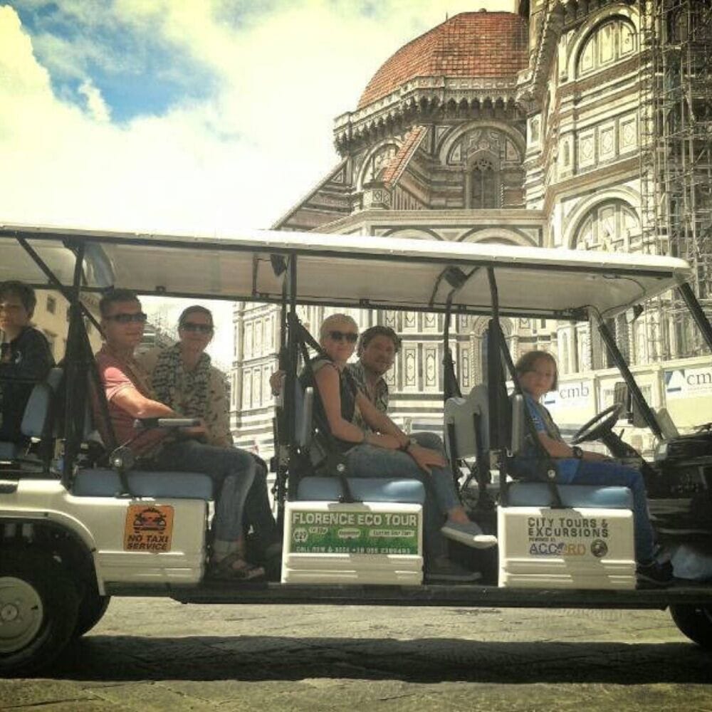 Electric golf cart with passengers on board in Duomo Square 