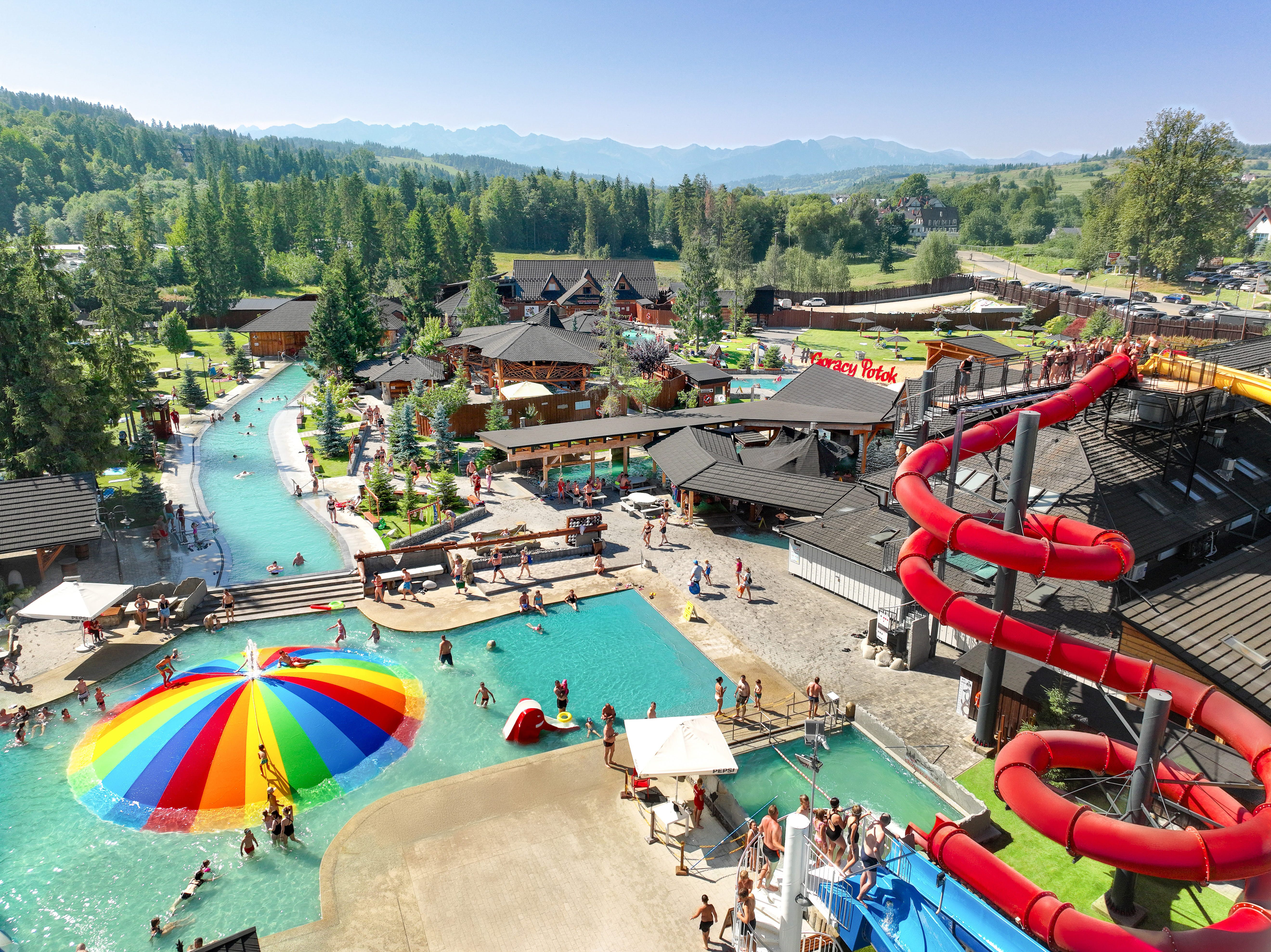 Gorący Potok Thermal Baths Szaflary aerial view — outdoor pools and water slides with Tatra Mountains