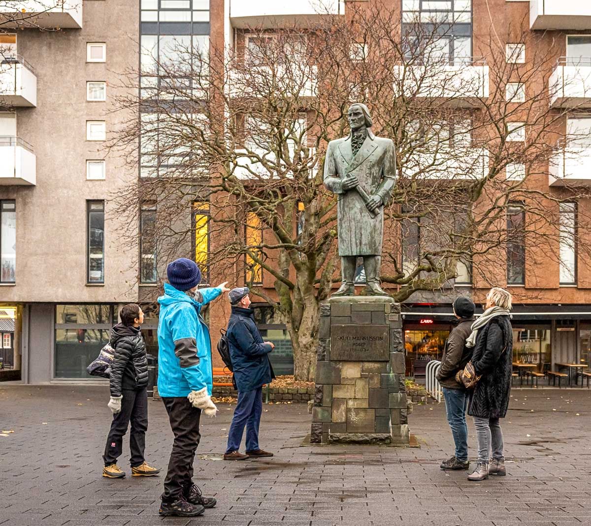 A guide from Your Friend in Reykjavik explaining the statue to a group.