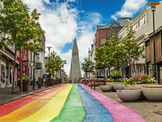 A picture of the Rainbow Street in Reykjavik with the Hallgrimmskirkja at the top