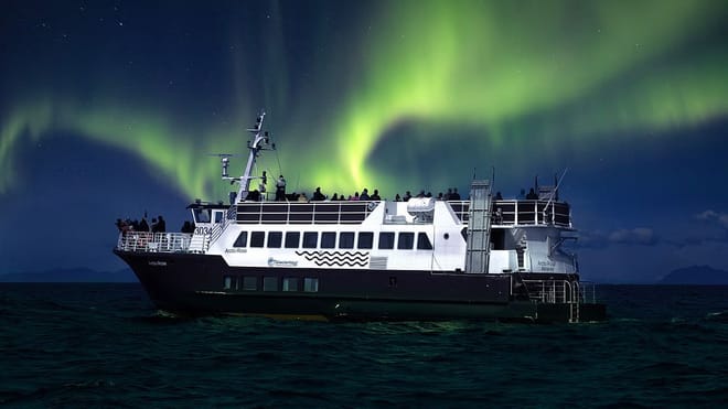 A Boat on the sea with the Northern Lights in the background