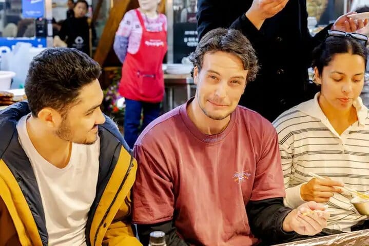 Experience authentic Korean street food at Gwangjang Market —A vendor at Gwangjang Market selling traditional Korean street food such as pancakes and seafood.