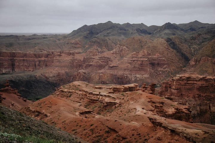 Panoramic view of Charyn Canyon with colorful cliffs and winding valley trails.