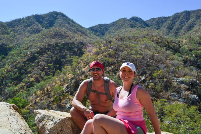 Couple resting during a desert hike on a Baja Jeep adventure near Santiago, Baja California Sur