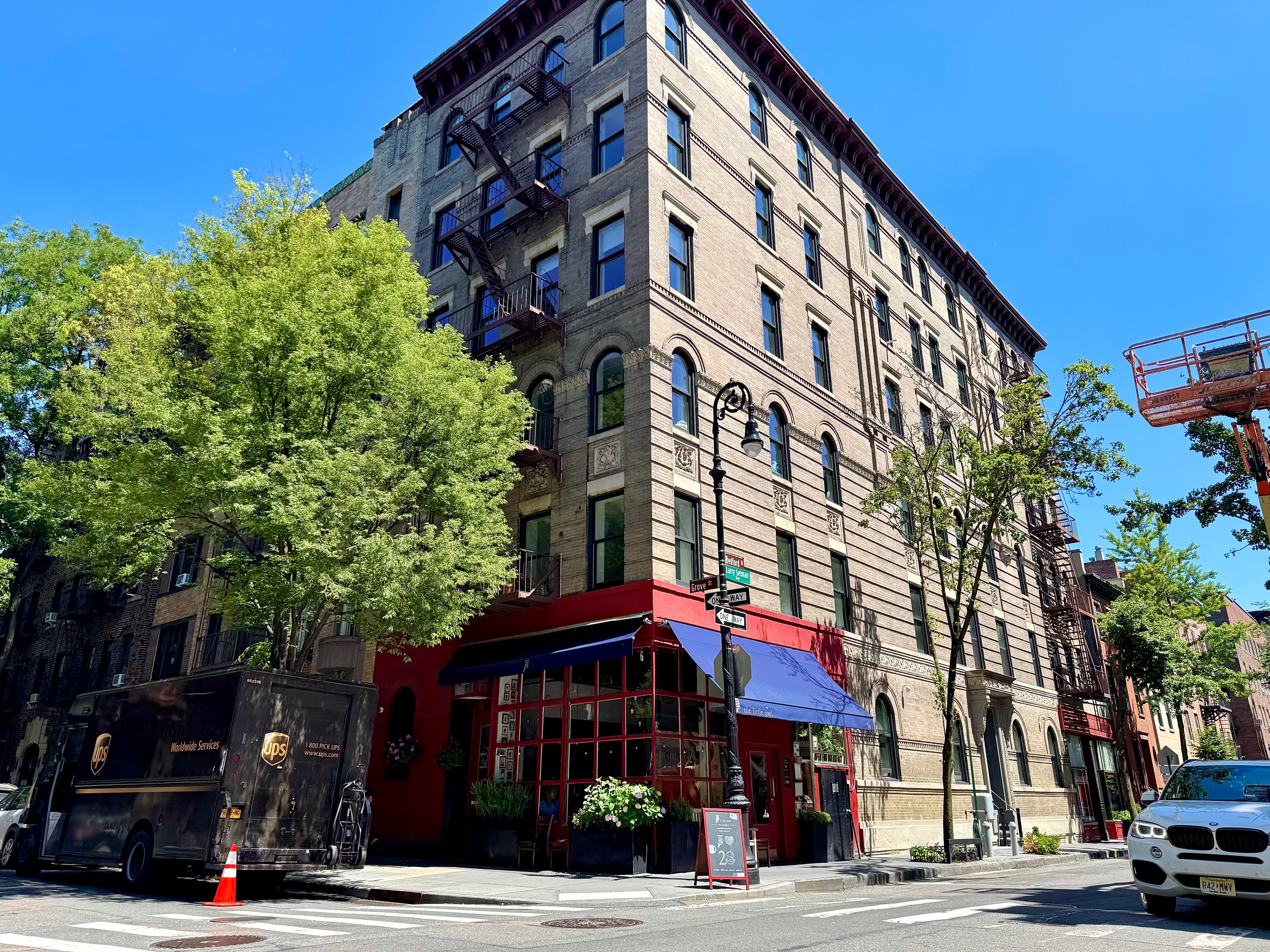 A multi-story historic apartment building on a Greenwich Village street corner.