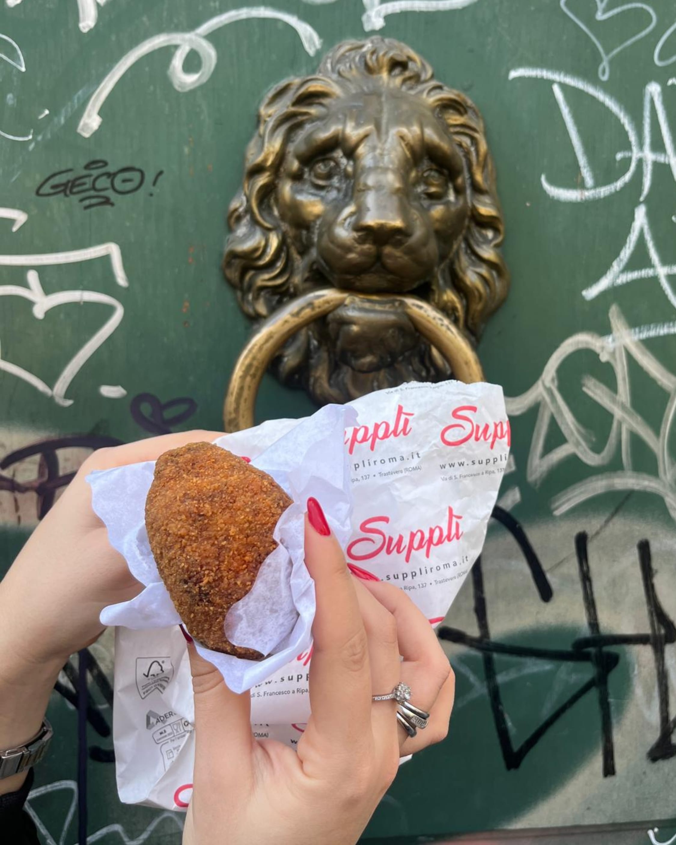 Freshly fried Roman Supplì ready to eat on the streets of Trastevere.