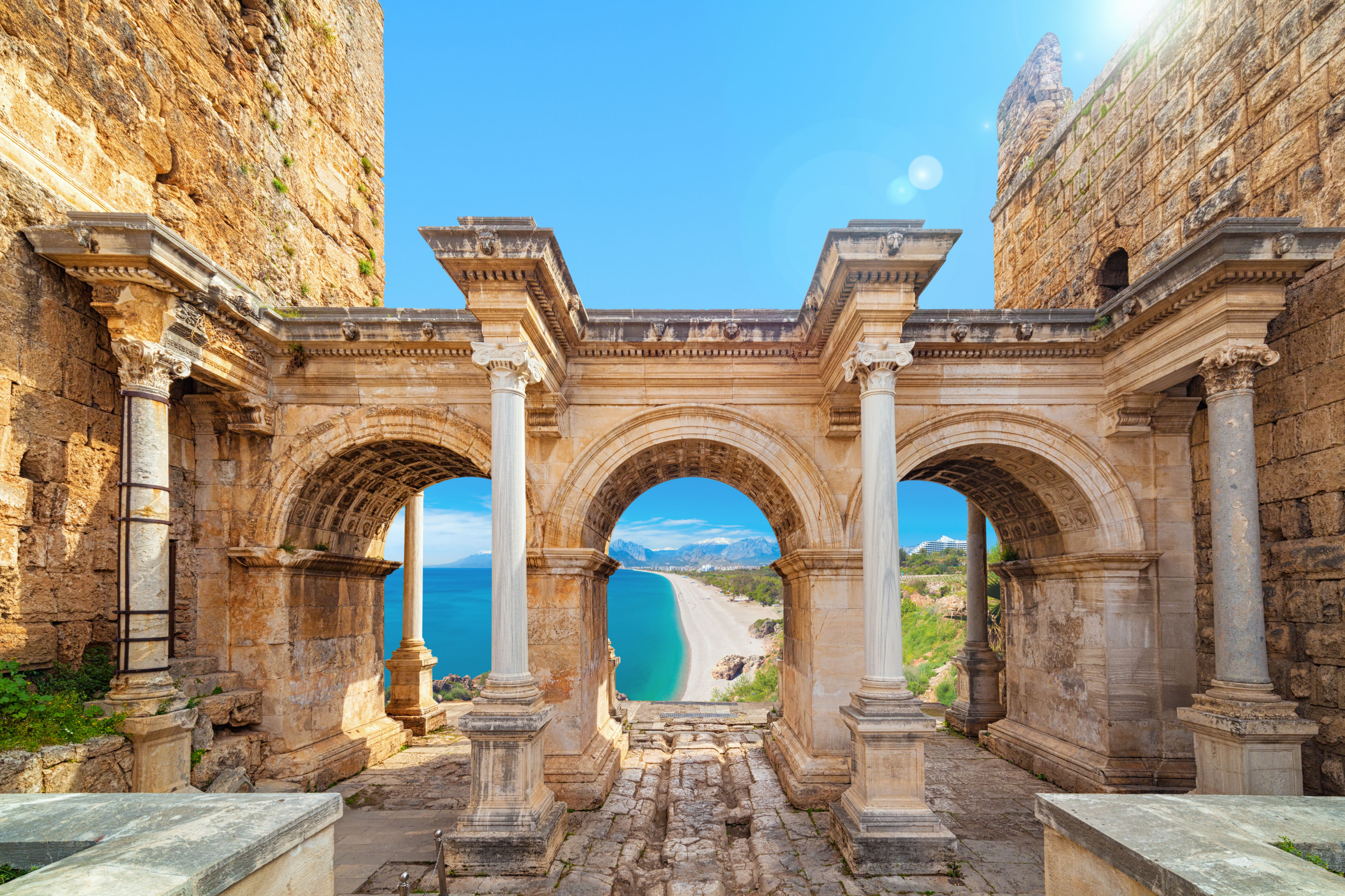 “Stone archway of Hadrian’s Gate in Antalya, featuring ancient Roman architecture with detailed carvings and inscriptions.”