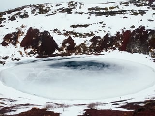 Kerið volcanic crater frozen and snow-covered in Iceland during winter