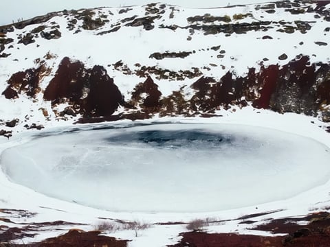 Kerið volcanic crater frozen and snow-covered in Iceland during winter