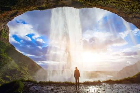 Seljalandsfoss Waterfall with Man behind Waterfall