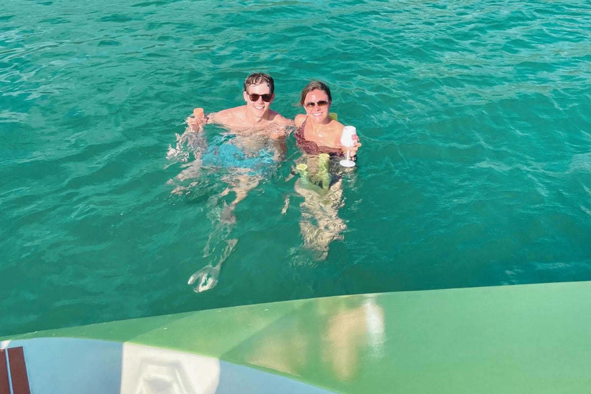 couple enjoying relaxing in the water with drinks