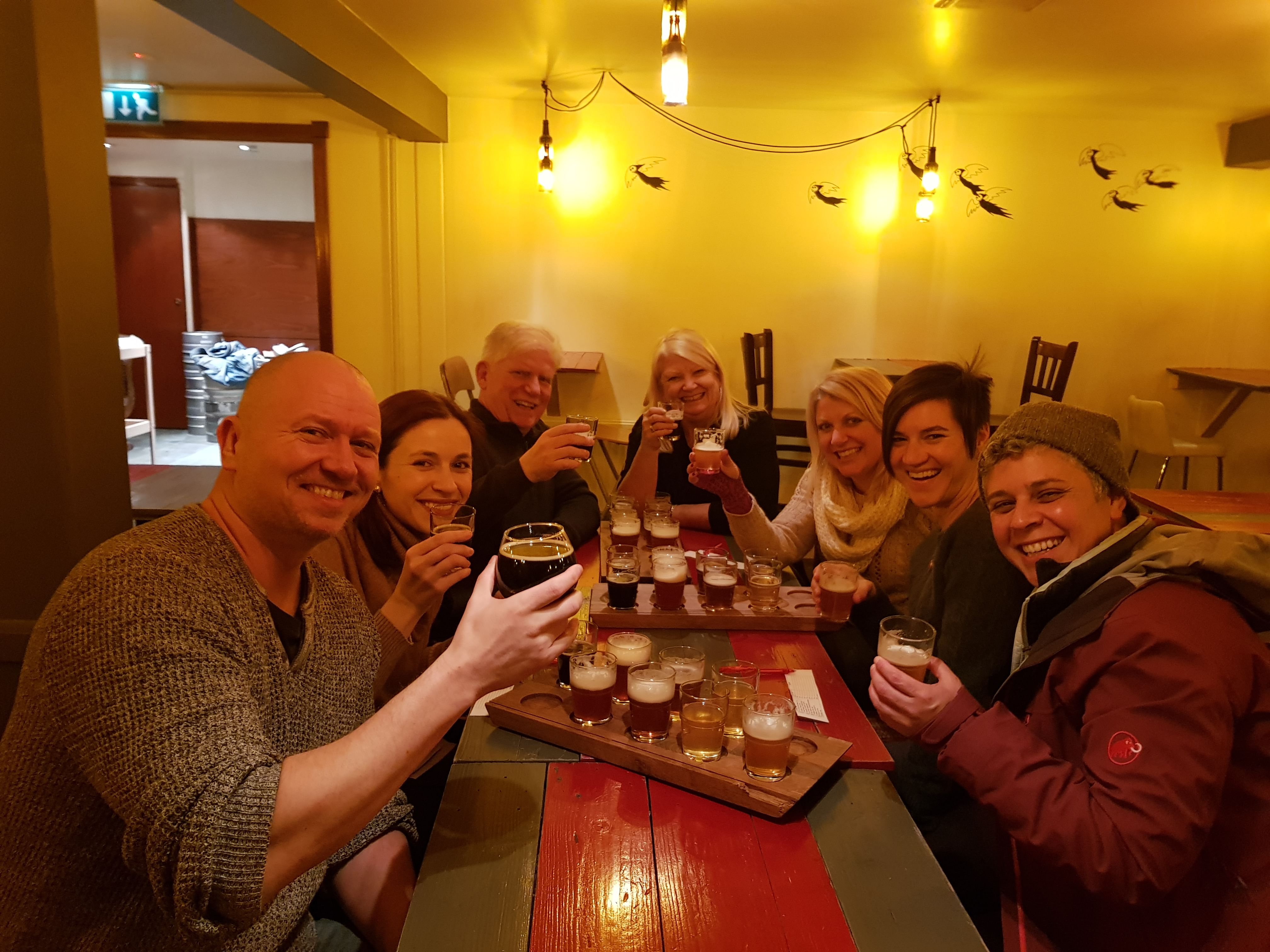 A group of guests enjoying a beer platter, sampling various locally crafted beers. 