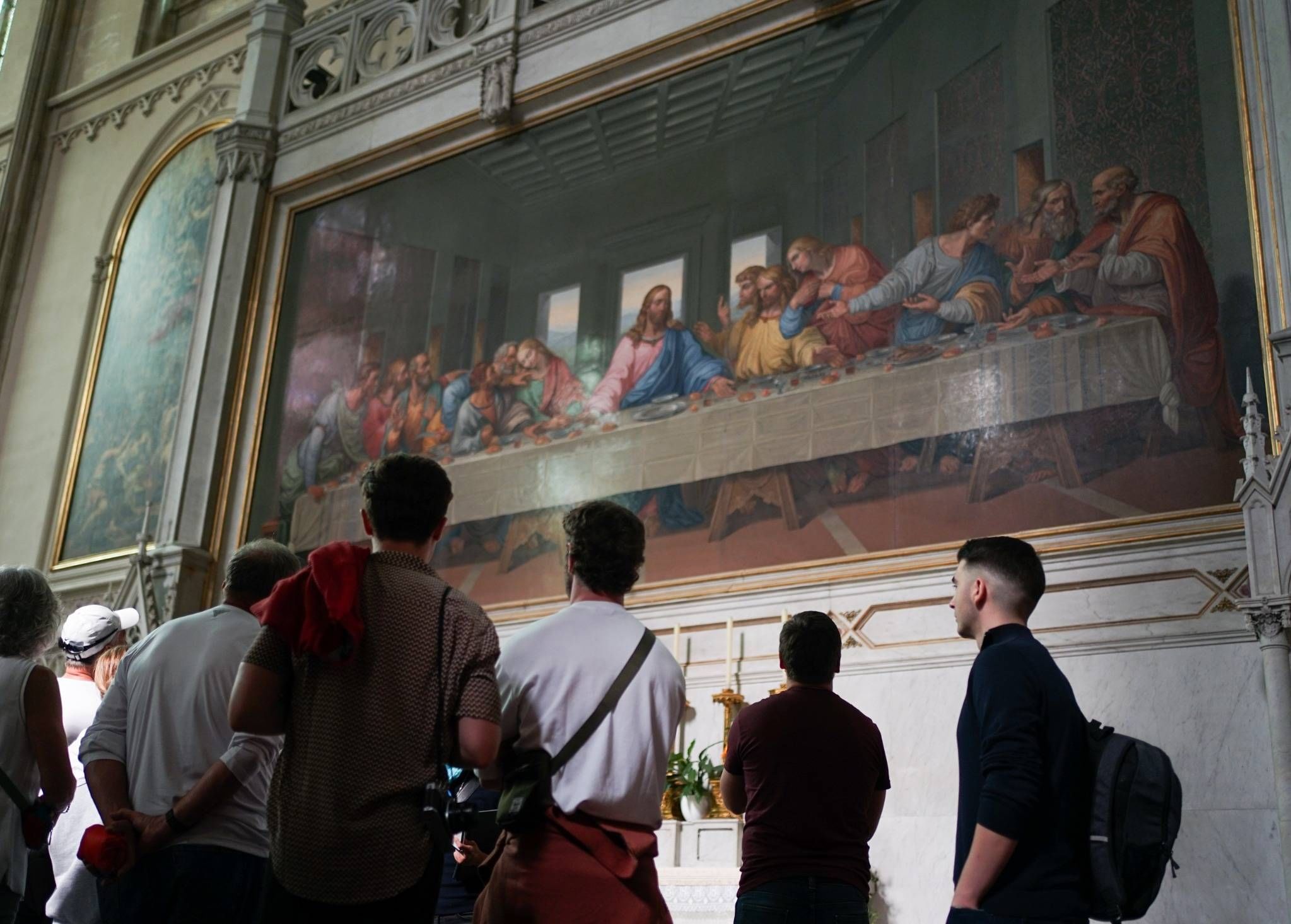 Tourists observing a large mosaic reproduction of Leonardo da Vinci’s The Last Supper inside Minoritenkirche, Vienna