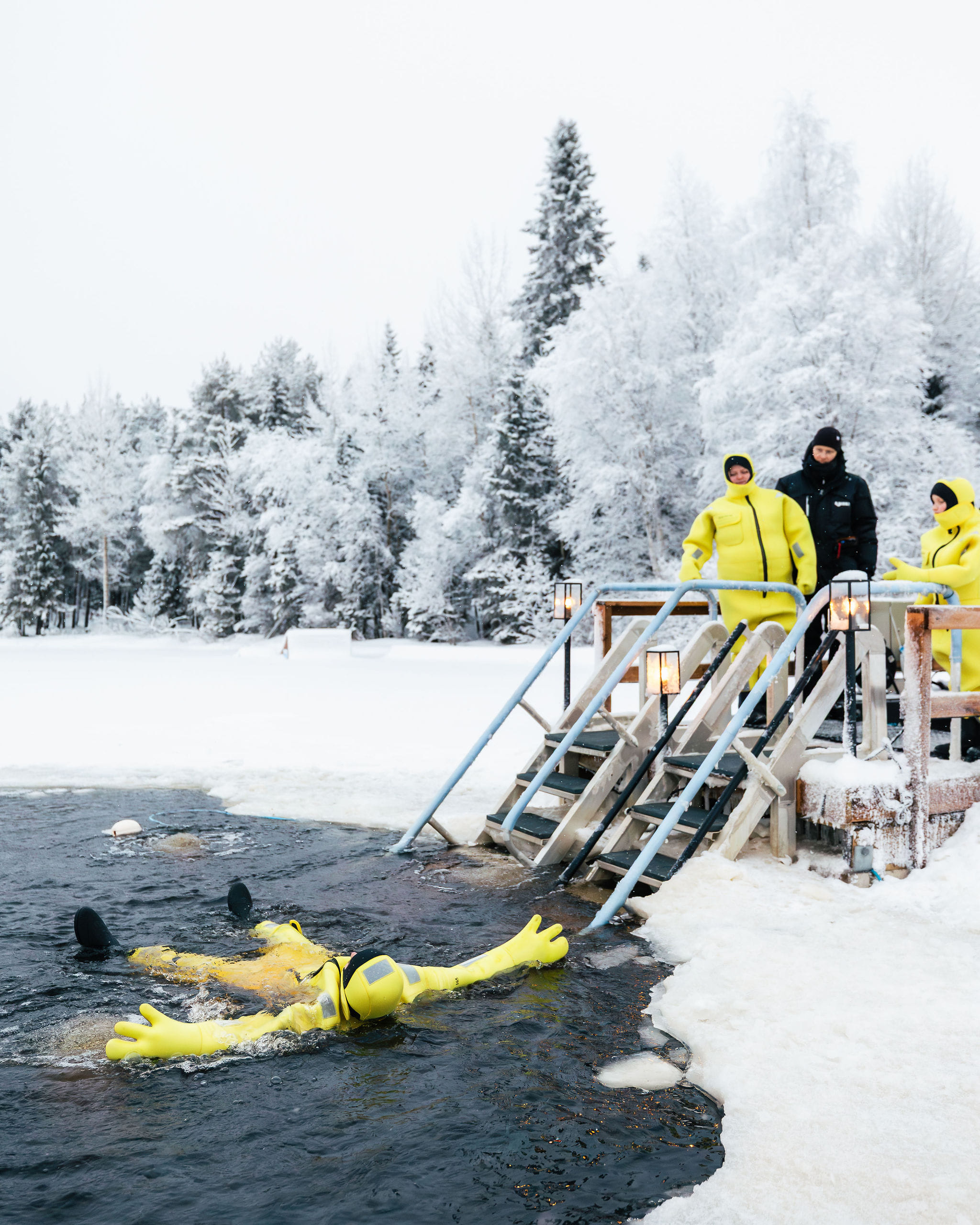 people floating in a frozen river
