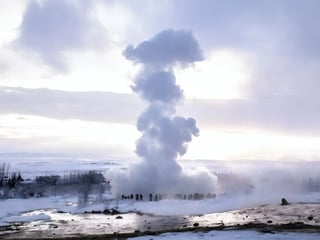 Strokkur geyser erupting with steam in Iceland’s geothermal valley during winter