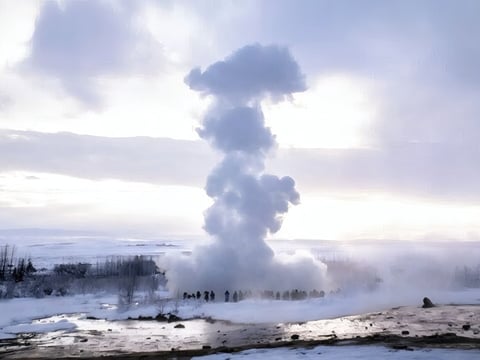 Strokkur geyser erupting with steam in Iceland’s geothermal valley during winter