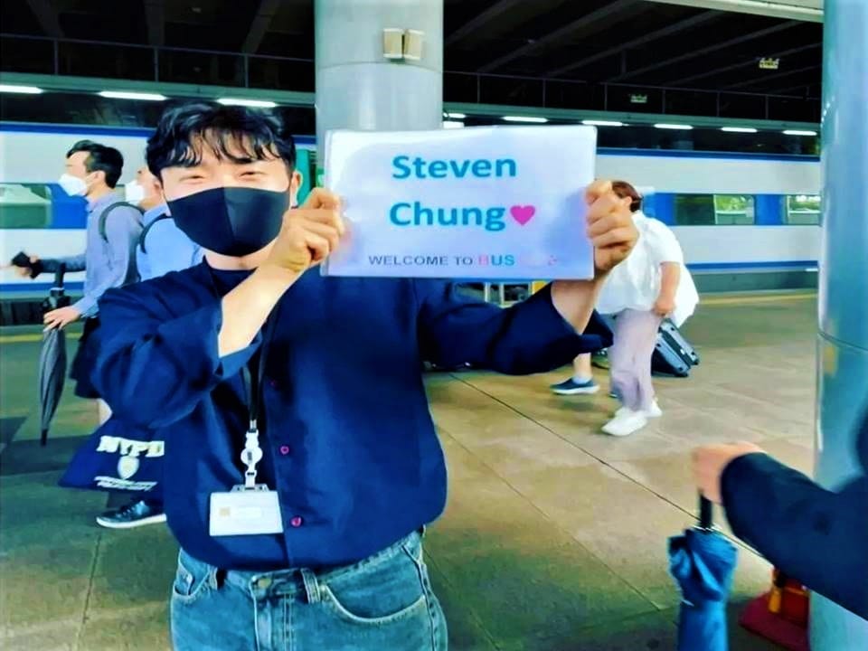 A friendly welcome during guest pickup at Busan Station.