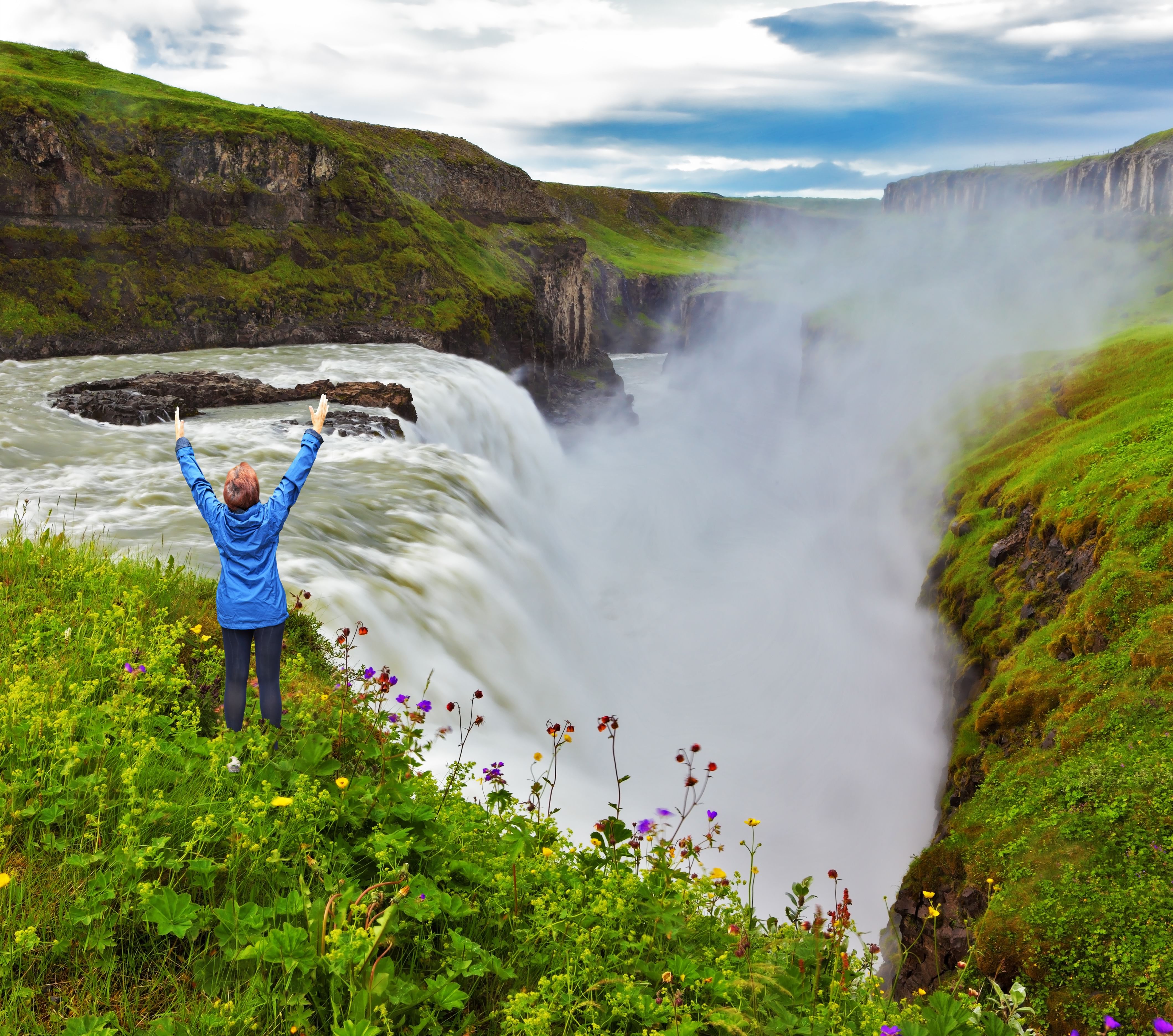 Gullfoss in Iceland with happy woman in front