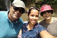 Tour guide Naomie in the middle of clients at the waterfall