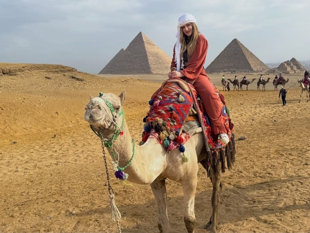 Traveler capturing Instagram Egypt photos at panoramic spot.