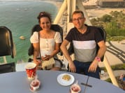 Guests in a comfortable dining capsule with the sea stretching out behind them.