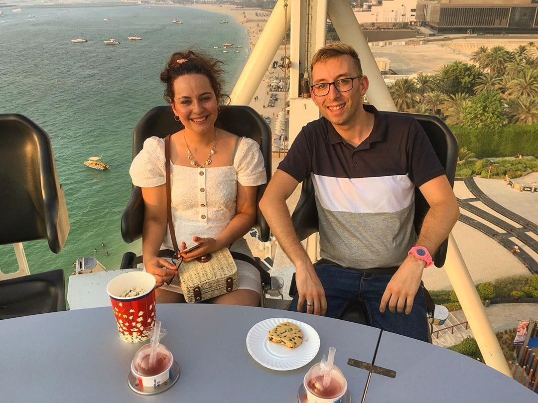Guests in a comfortable dining capsule with the sea stretching out behind them.