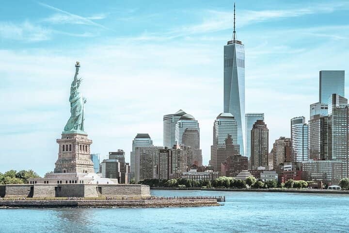 Statue of Liberty and Manhattan skyline viewed from New York Harbor waters
