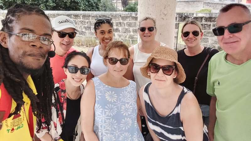 Group of guests with tour guide Kristin at Codd Monument, a stop on our guided history walking tour in Bridgetown.