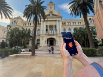 Visit Malaga in freedom: In front of the majestic City Hall (Ayuntamiento) and its palm trees.