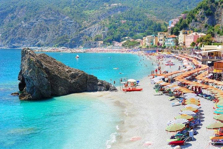 View of the seaside in Monterosso, with blue water and white sand