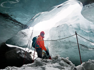 Person walking into the ice cave