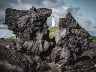 View of Reykjanes lighthouse caputerd between lava formation