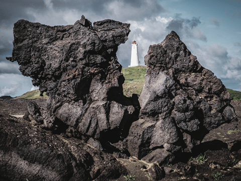 View of Reykjanes lighthouse caputerd between lava formation