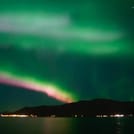 Spectacular Aurora Borealis display over the ocean near Reykjavík