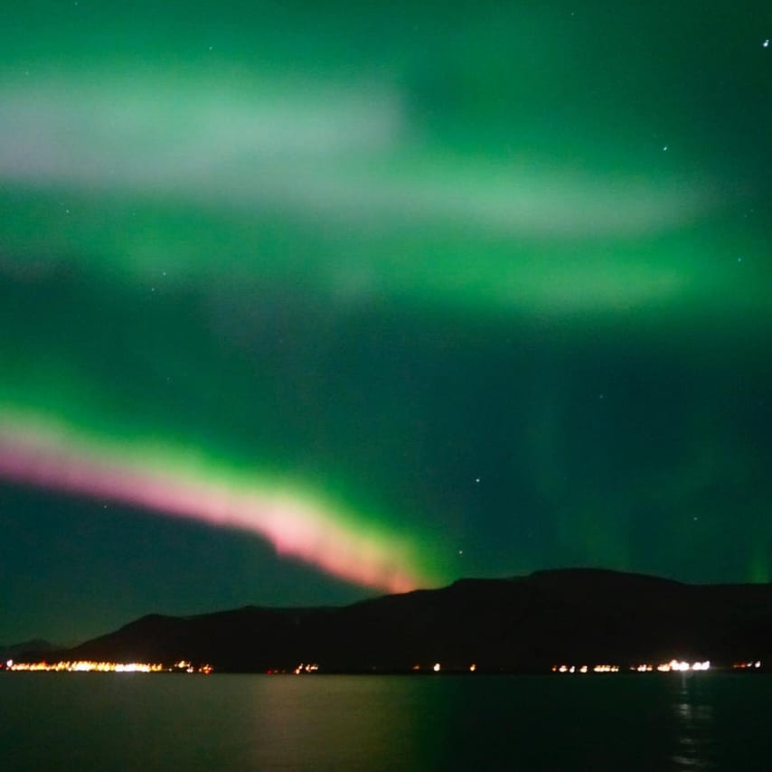Spectacular Aurora Borealis display over the ocean near Reykjavík