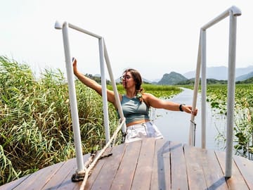 Sail through Lake Skadar’s tranquil waters on a boat tour to the charming village of Karuč.