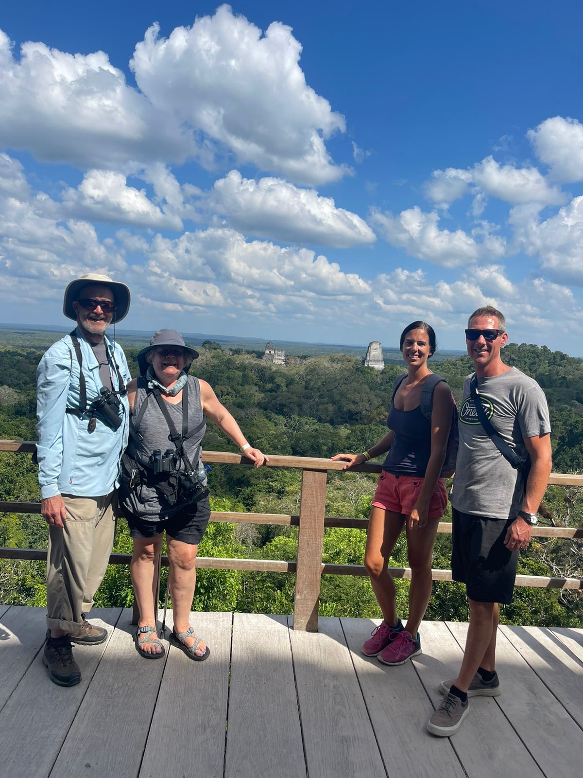 4 people high on a viewpoint at Tikal