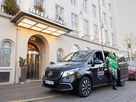 A traveller exiting a Tour Vehicle from Your Friend in Reykjavik