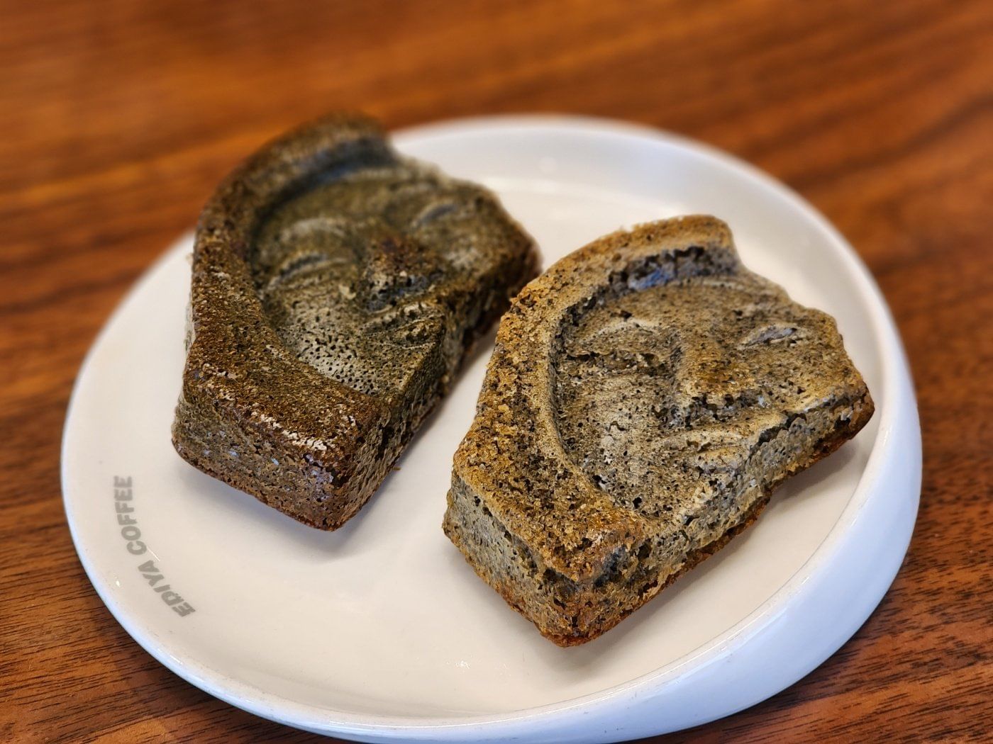 A cookie decorated with the smiling face from the Smile of Silla sculpture.