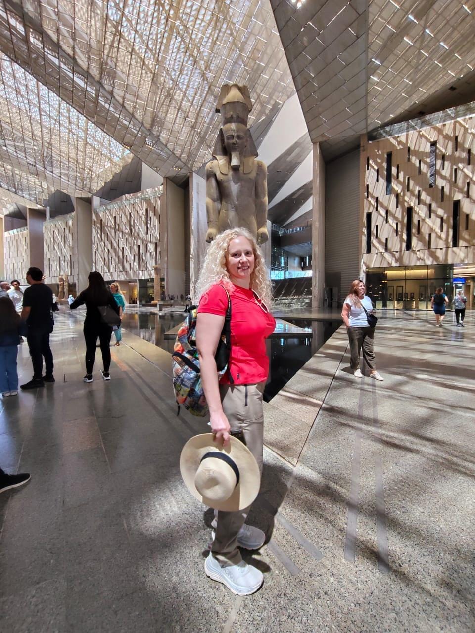 Tourists capturing iconic shots at Ramses II statue during Egypt cultural tours.