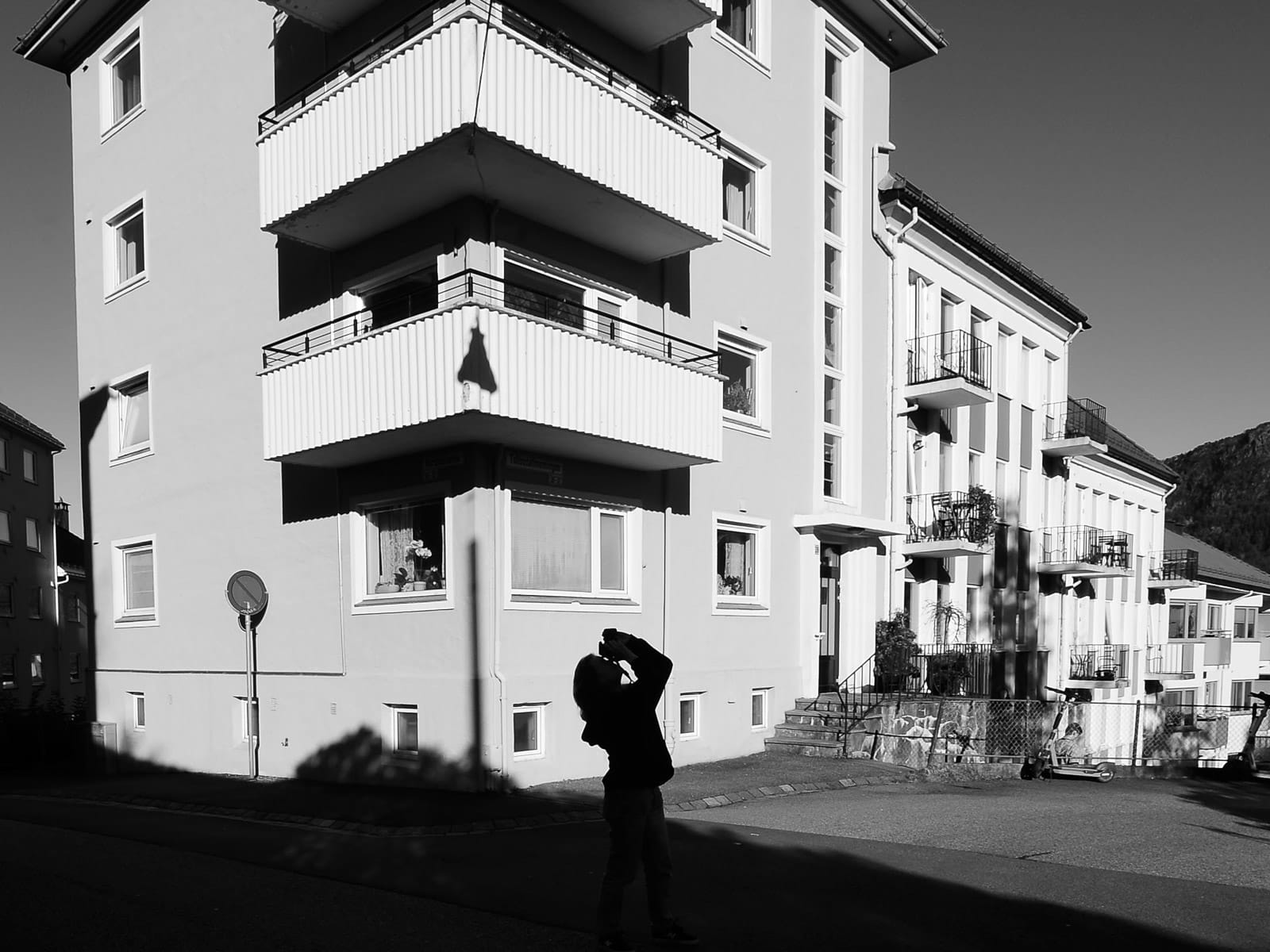 Black-and-white street scene with strong shadows and a lone figure, showing the creative observation practiced during the photowalk.