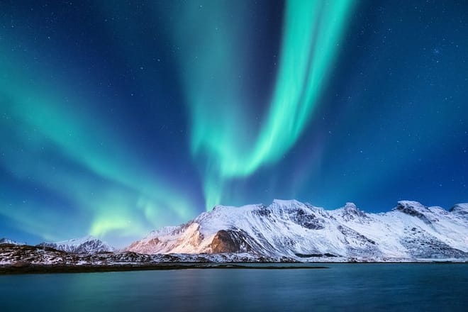 Northern Lights over a snow-covered mountain in Iceland