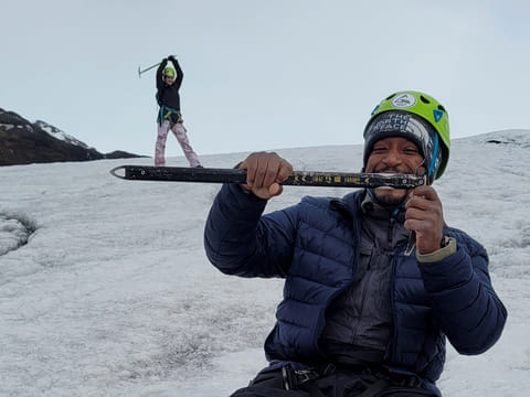 Making illusion where the woman is very small and standing on the man's ice-axe