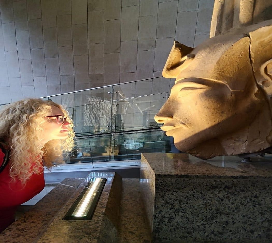 Travelers standing inside the Grand Egyptian Museum Cairo during a private Egypt tour.