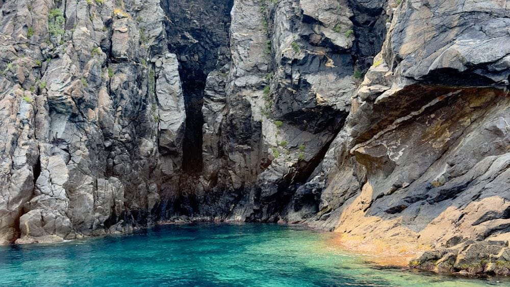Natural sea cave along the Costa Viola with clear turquoise waters